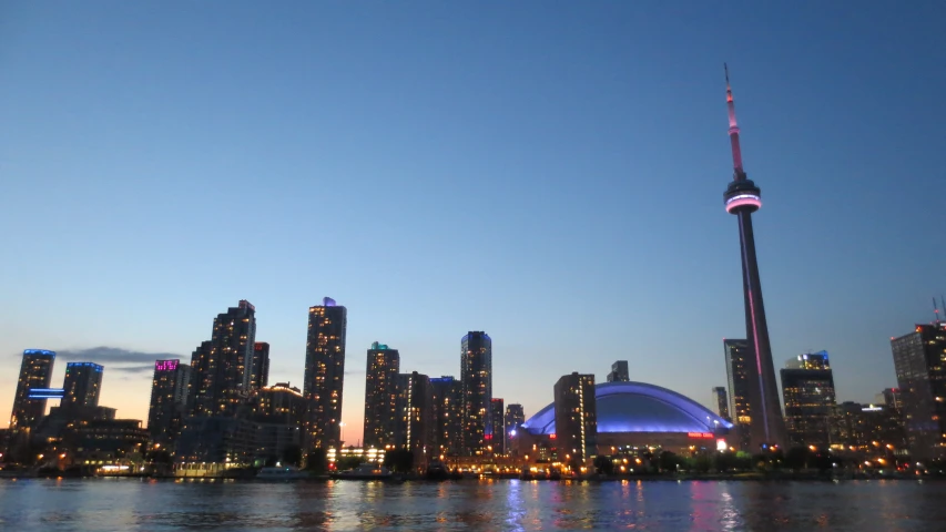 the lights of the large buildings reflected in the water