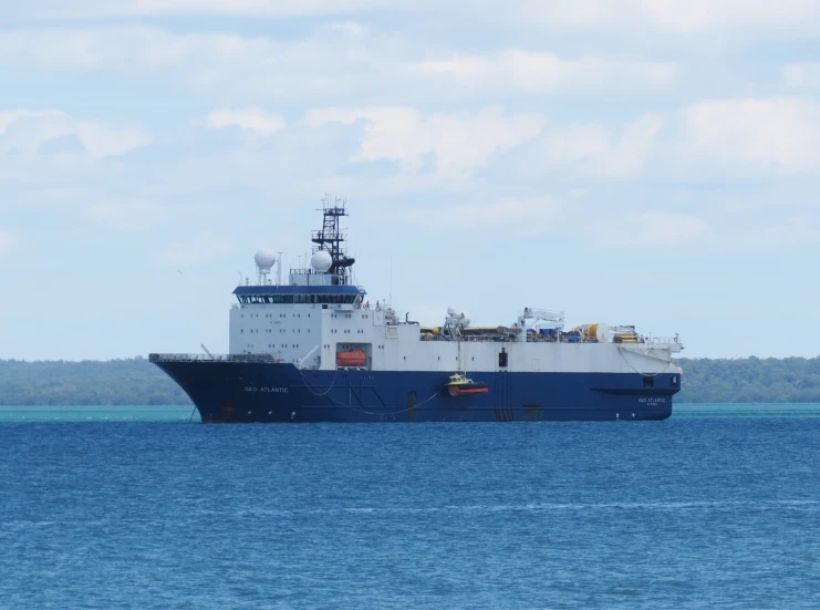 a large ship in the water off shore