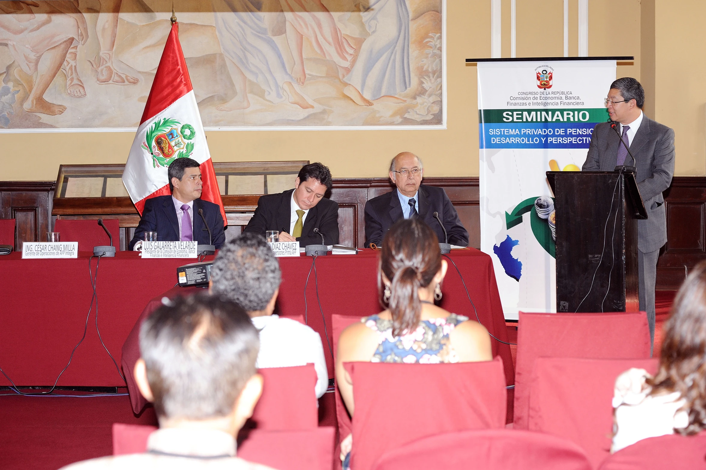 three people at a podium during a presentation