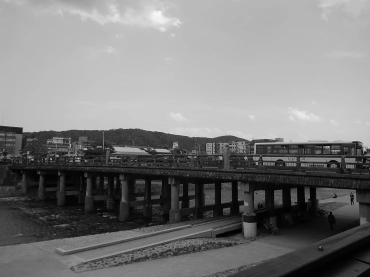 black and white pograph of a bridge with cars driving on it