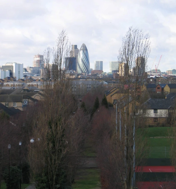 a view of the city in the distance, from the park