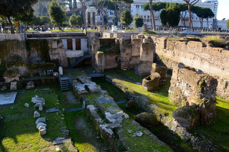 ruins in the middle of a large courtyard with several stairs on it