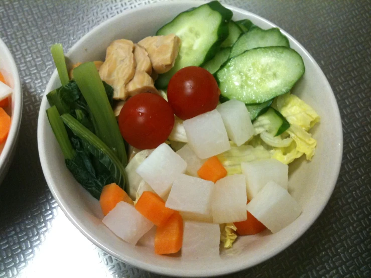 a couple bowls filled with different types of fruits and vegetables