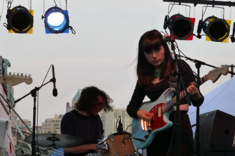 an image of some people playing guitars on stage