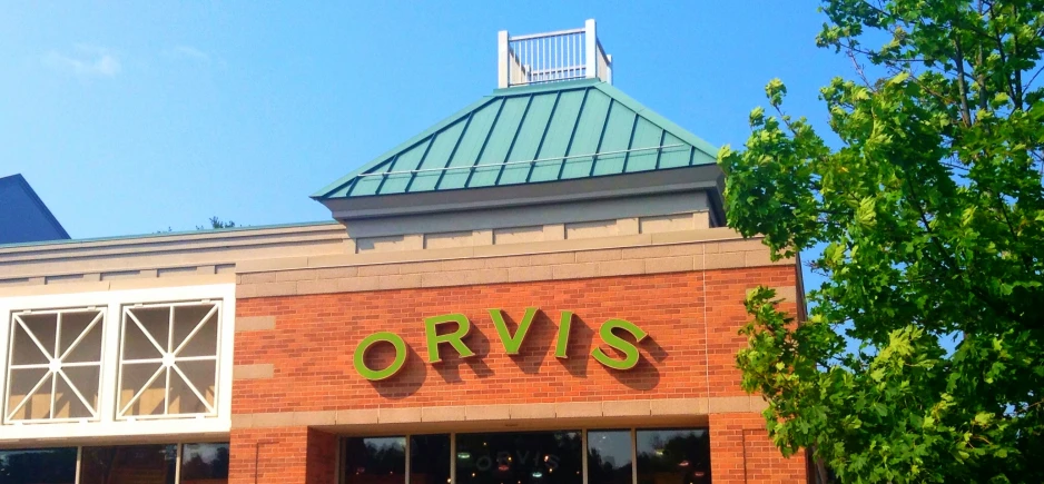 a view from a street level looking up at the top of a store