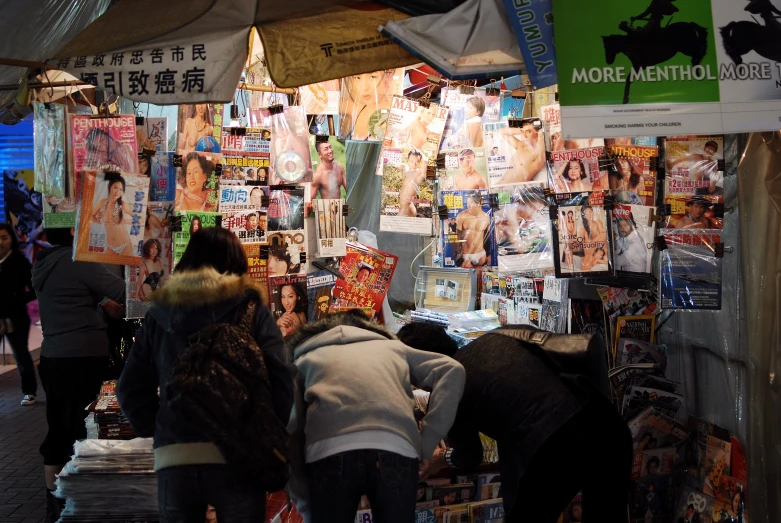 a few people standing inside of a book shop