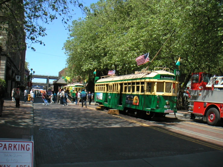 a trolley on a street that is surrounded by trees