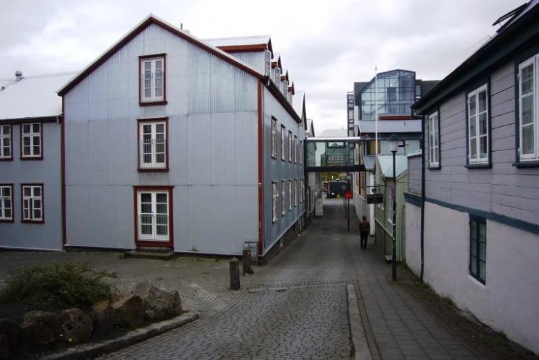 there is a long road in front of buildings