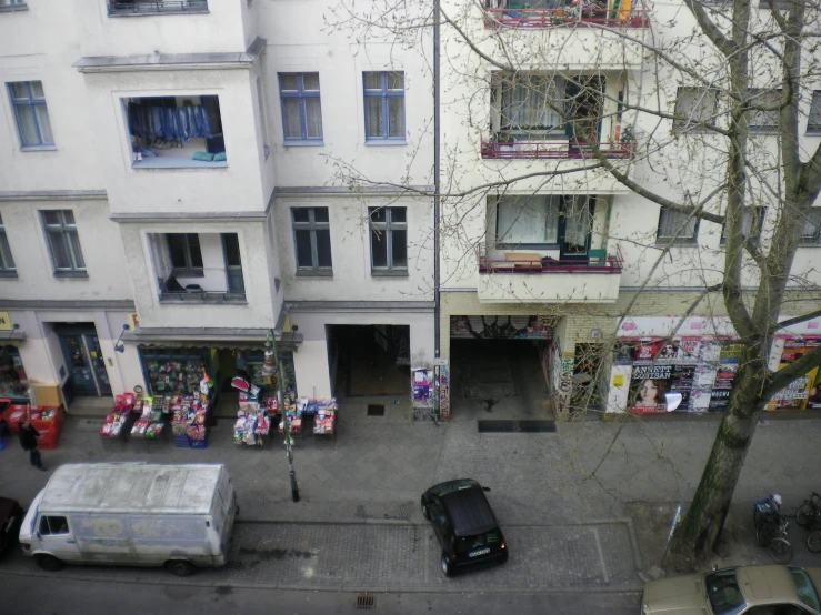 the view from above of a building and vehicles on the street