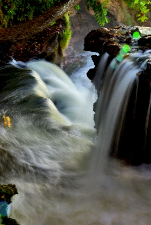 a stream flowing over rocks into a stream