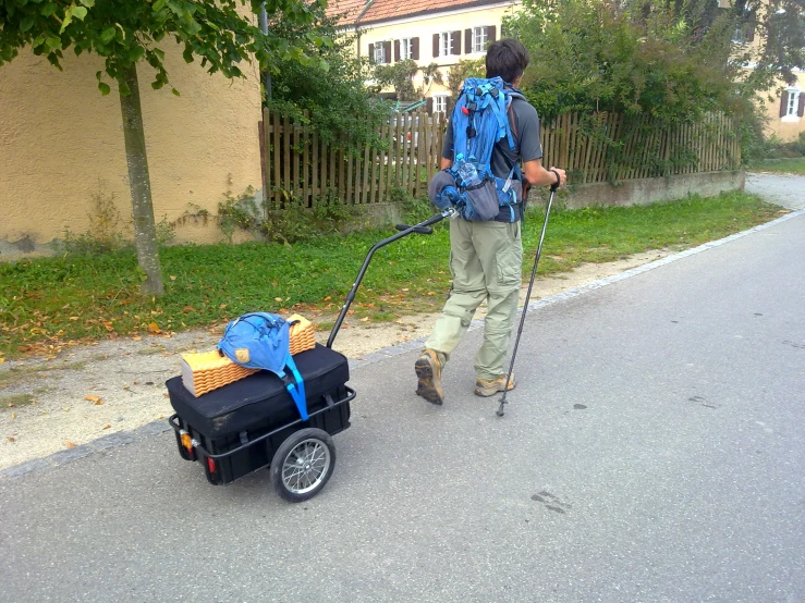 a person is walking with a luggage cart