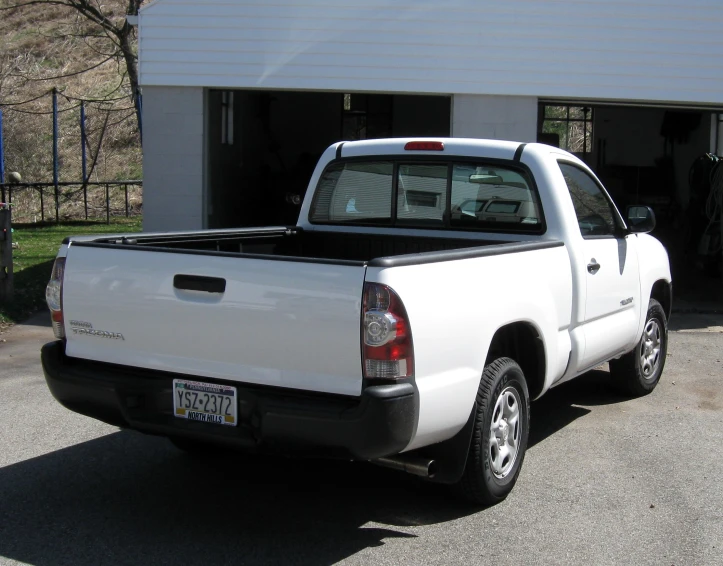 a white pick up truck parked in a garage