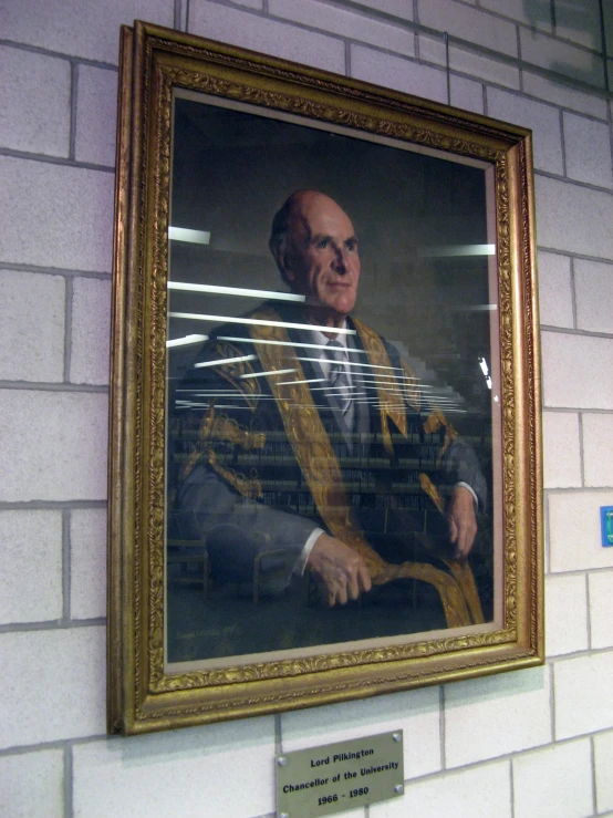 a painting hangs above a brick wall of a judge