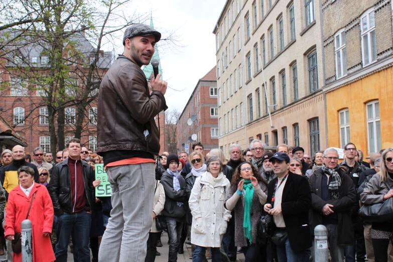 a man in a crowd with people taking pos