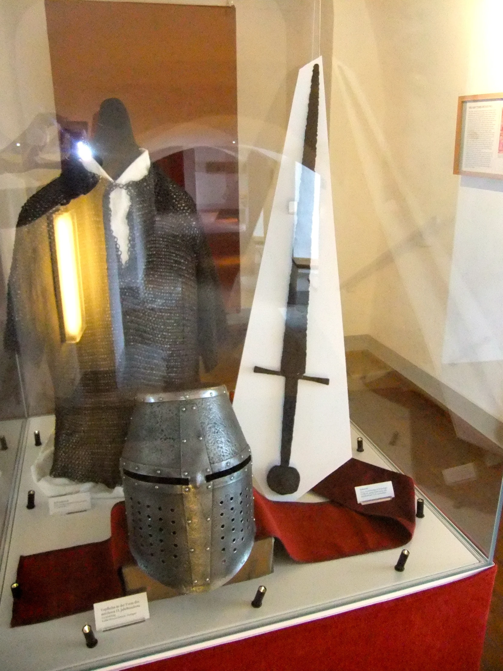 an exhibit case with medieval armor on display