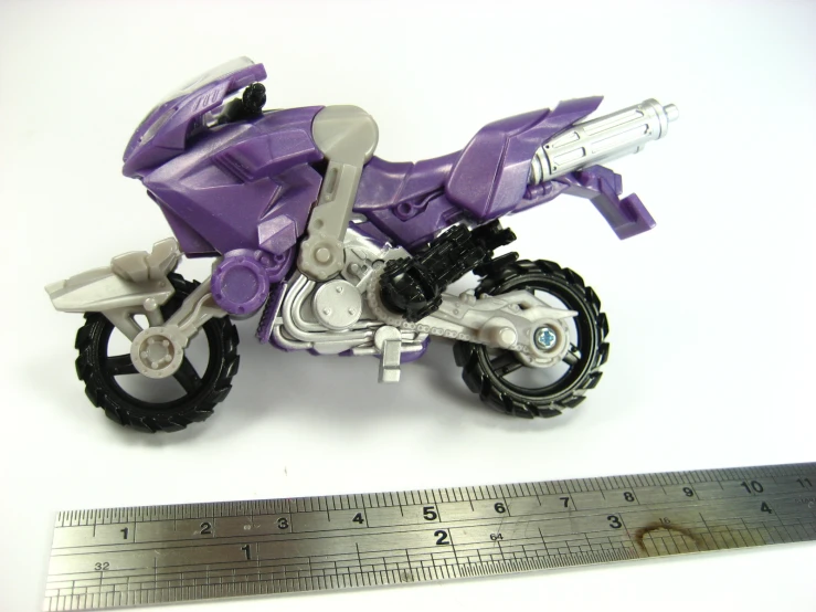 a small toy motorcycle on a white table