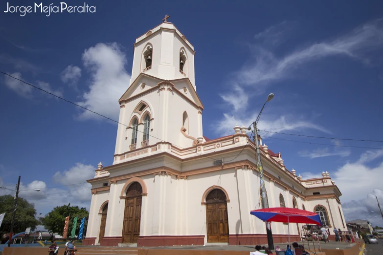 people walking around and looking at an old church