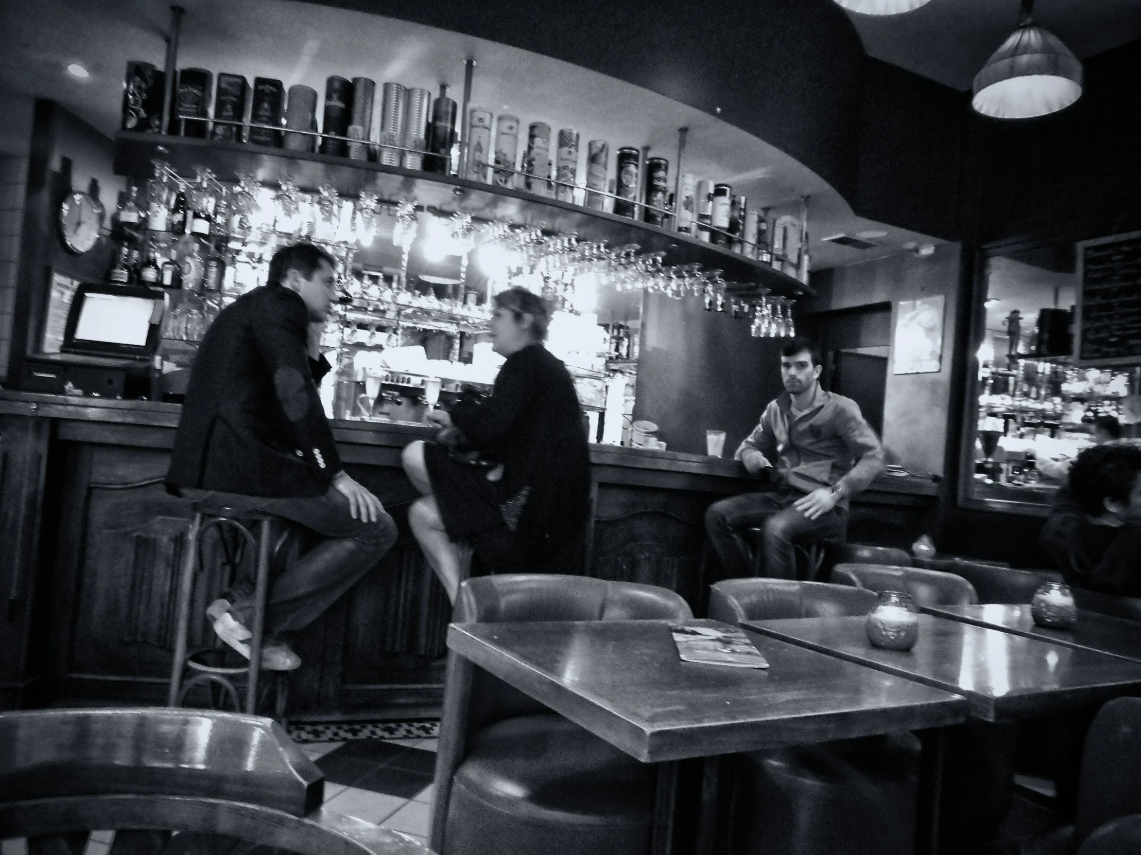 a group of men standing around a bar