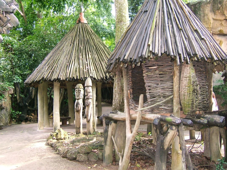 several old wooden house made of sticks and nches