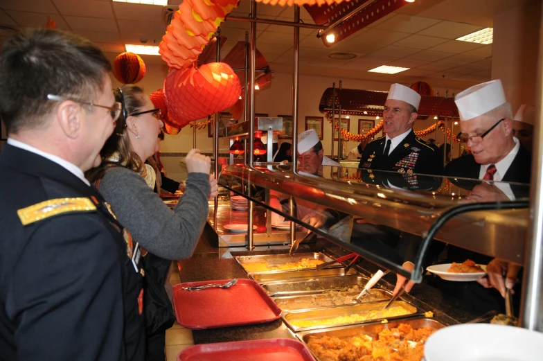 three guys serving food at a restaurant together