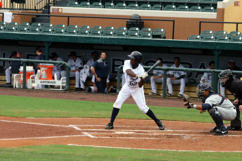 a baseball player holding a bat on a field