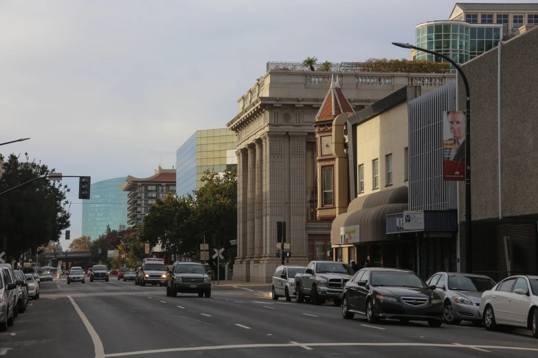 cars driving down the road in a city