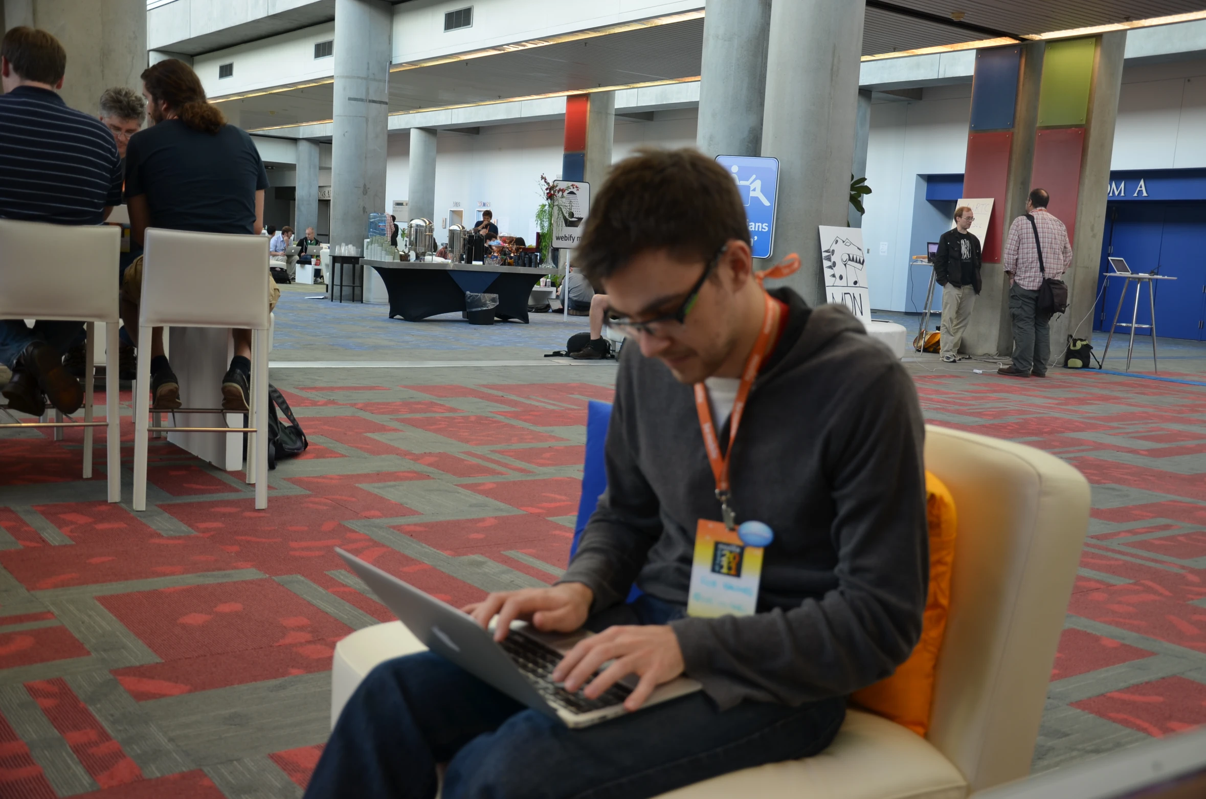 a person on a laptop sitting on a chair