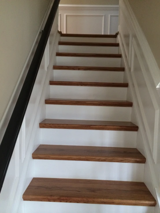 a staircase leading up to a bedroom with beige walls