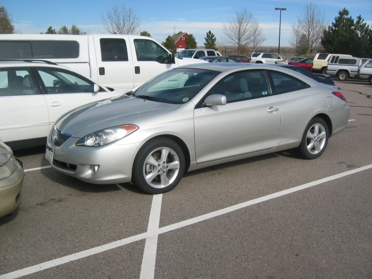 silver car with flat tires parked in parking lot