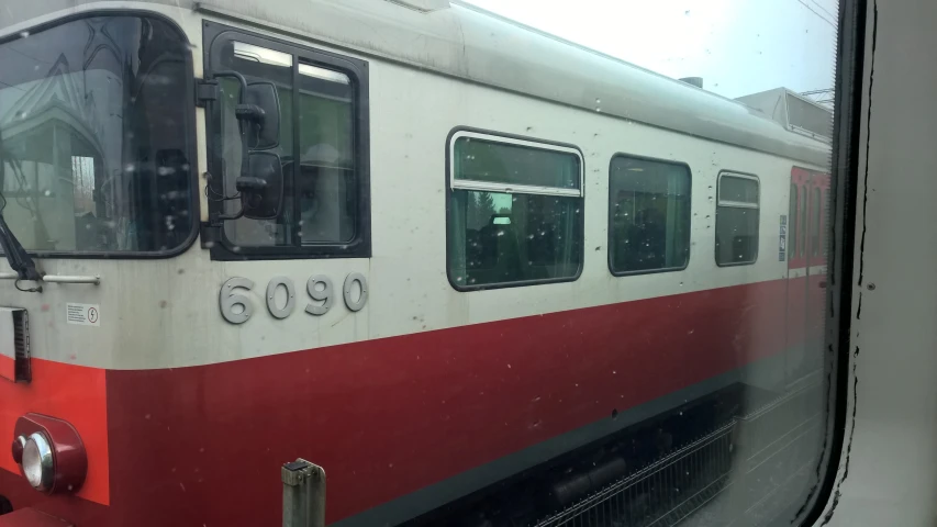 a passenger train parked at the side of a train station