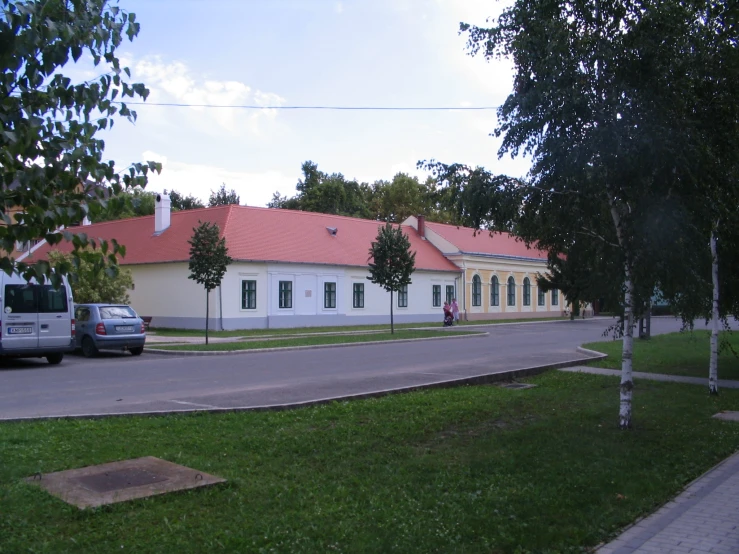 a long white house with red tile roofs