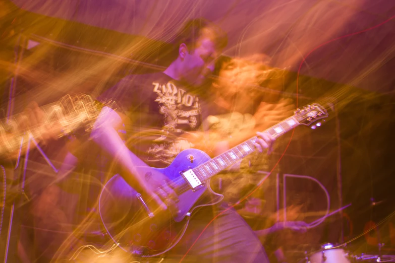 a young man is playing an electric guitar