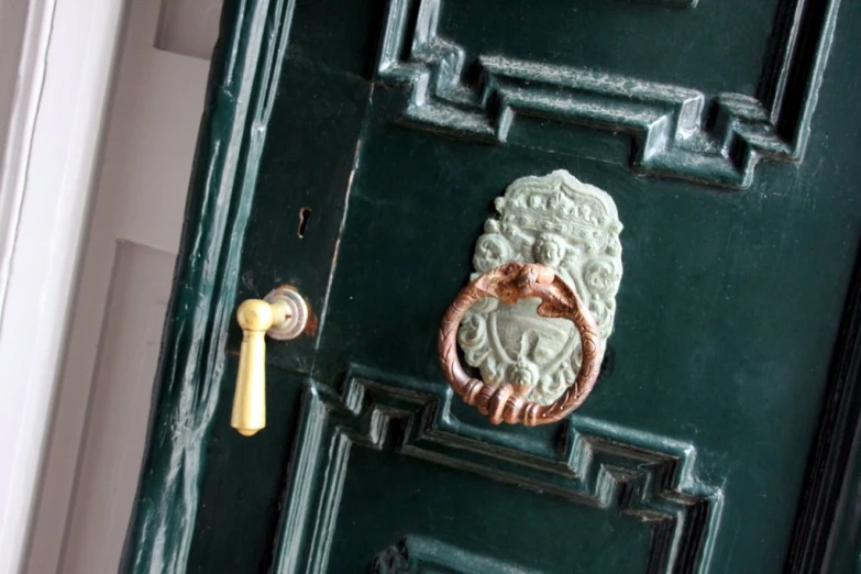 an old fashioned handle on the door of a green house