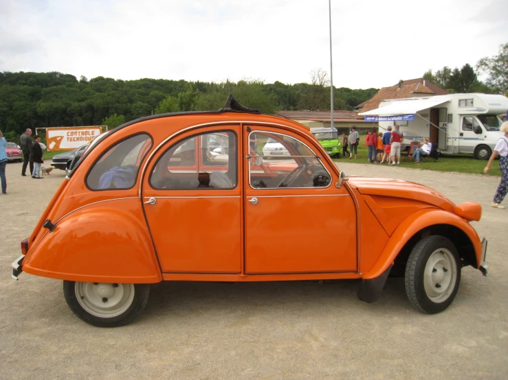 an orange and black car in a parking lot