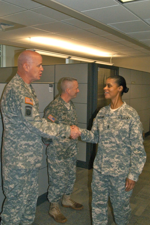 two men in uniform are shaking hands