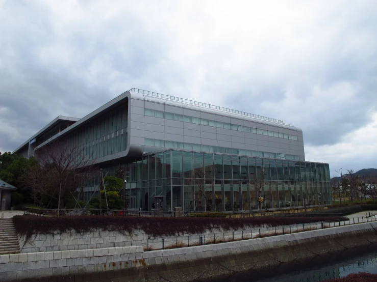 a glass building and some steps by some water