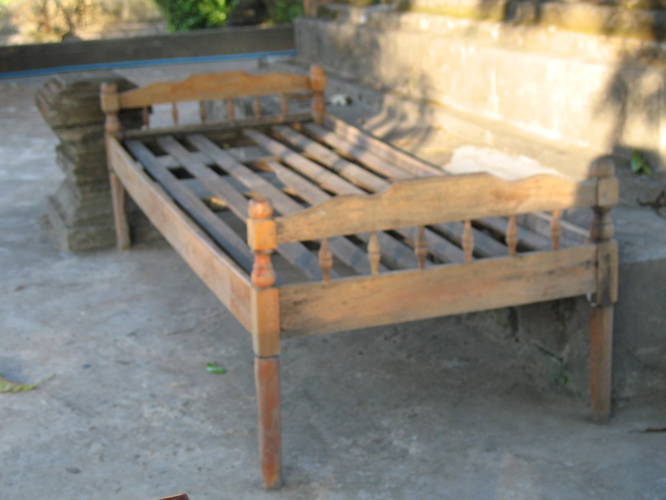 an old, worn up bed frame with nailing on the sides