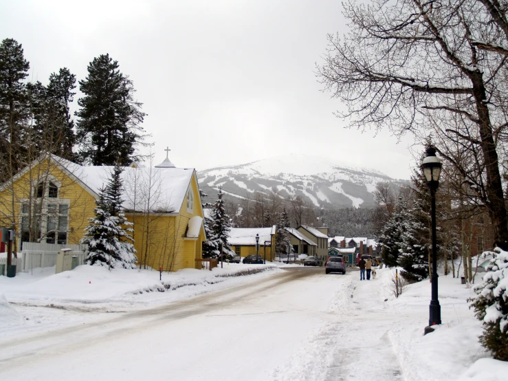 a street lined with small yellow houses in a city