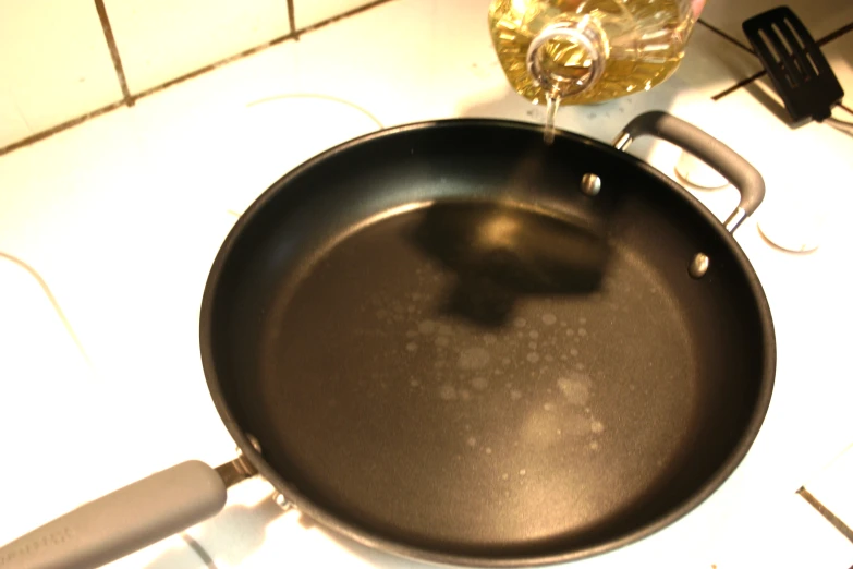 a frying pan with a dirty wok on the stove top