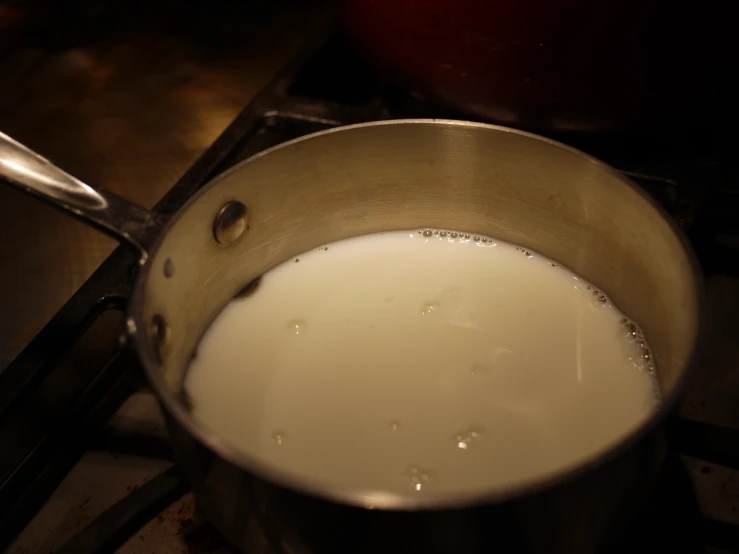a pan filled with a full jug of milk