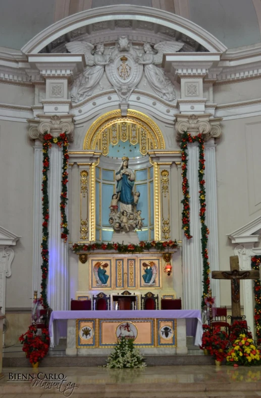 a large, ornate church has a white wall and decorated with festive decorations