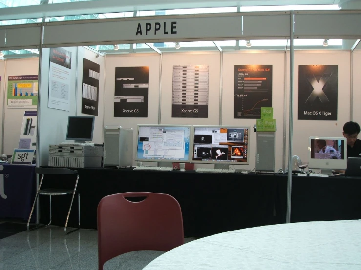 some computers on tables and people on the wall