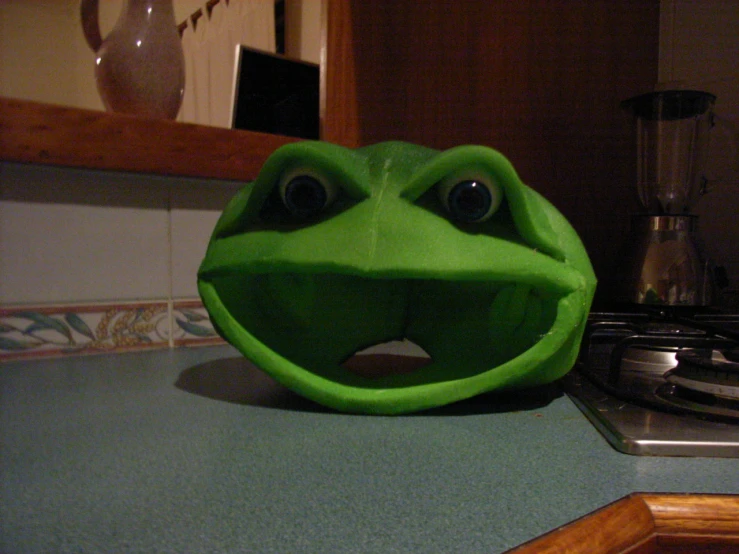 frog ball face next to a gas stove