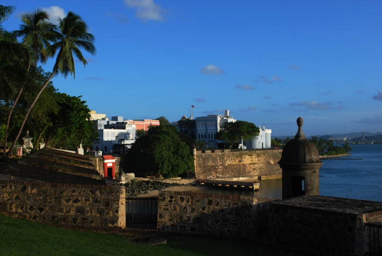 an ancient wall in front of a large body of water