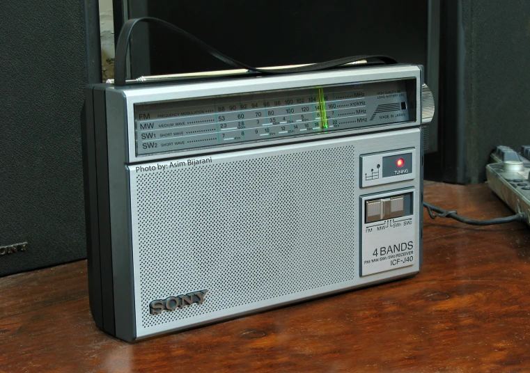 a radio and a remote control sit on a table