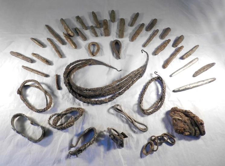 a collection of various types of metal knives and chains