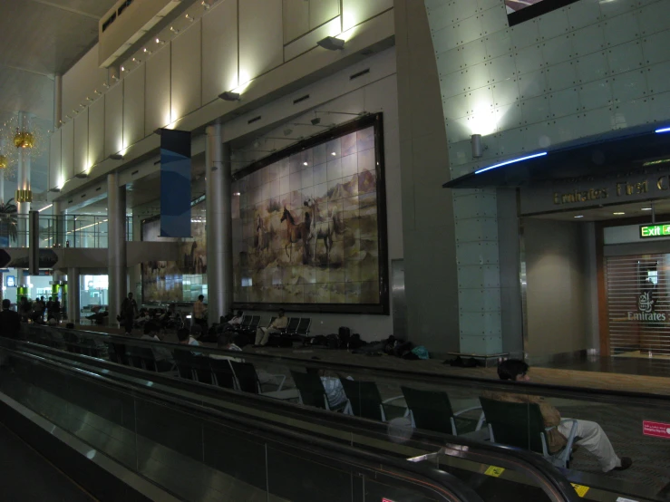 an empty airport waiting area with seating and bags