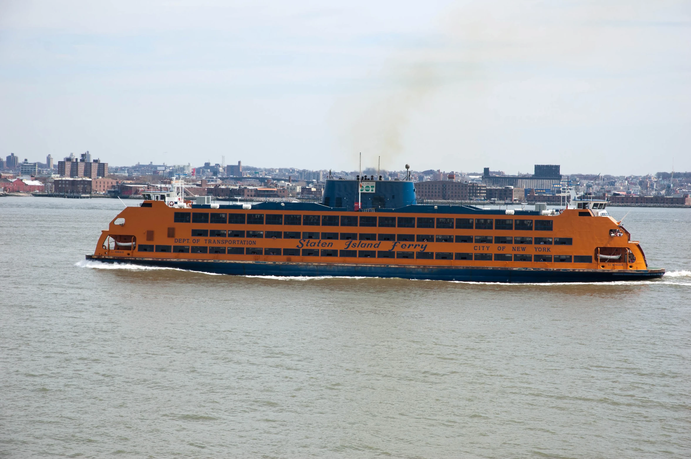 there is a large orange boat in the water