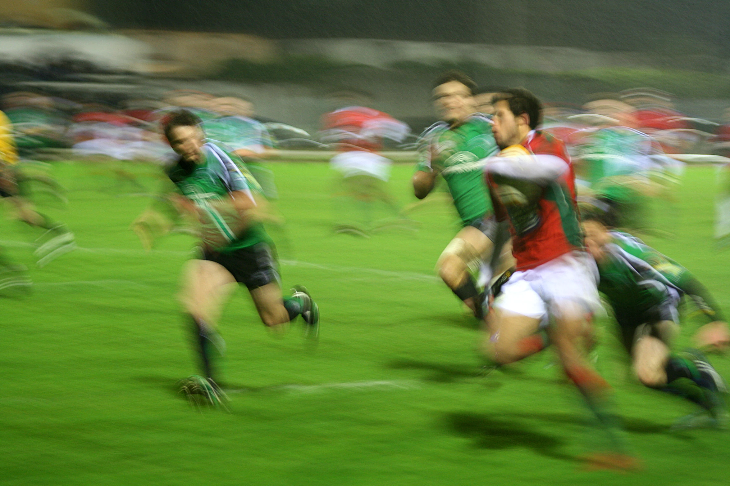 a group of people running across a soccer field