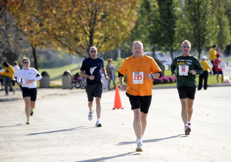 men running on a path and trees in the background